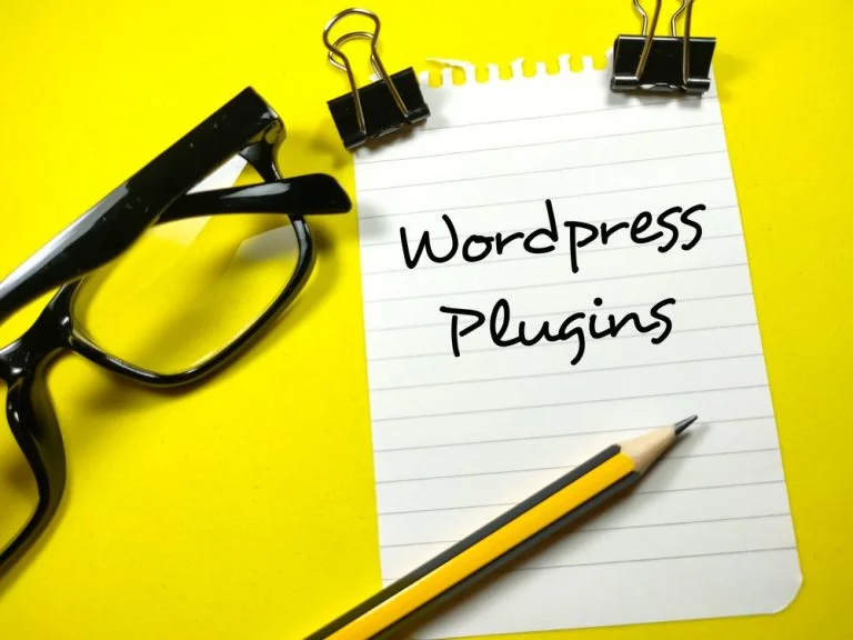 WordPress Plugins written on a notepad.