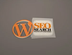 Image featuring the WordPress logo on the left, styled in orange, and a graphic to the right with the text 'SEO Search Engine Optimization' in bold orange and black lettering, placed on a light gray background with various internet-related icons.