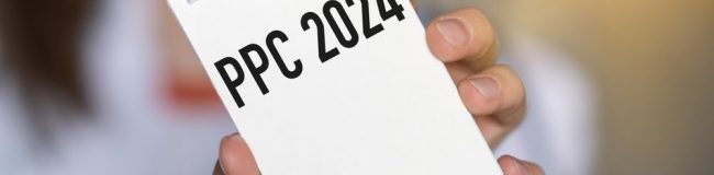 PPC written on a notepad, which is being held up by a woman.