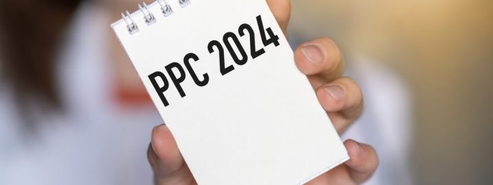PPC written on a notepad, which is being held up by a woman.