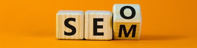 Wooden cubes turning and showing SEO and SEM