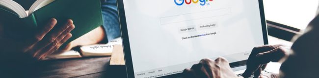 Man Using Laptop Browsing Google Website