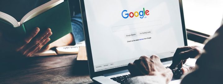 Man Using Laptop Browsing Google Website