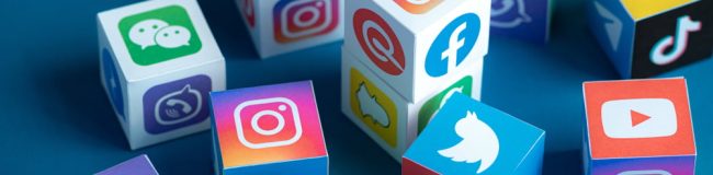 Different social media platform logos on cubes.