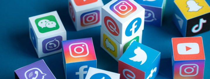 Different social media platform logos on cubes.