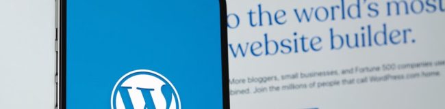 WordPress,Logo,Mobile,App,On,Screen,Smartphone,Iphone,With,Macbook Simple WordPress website on computer screen.